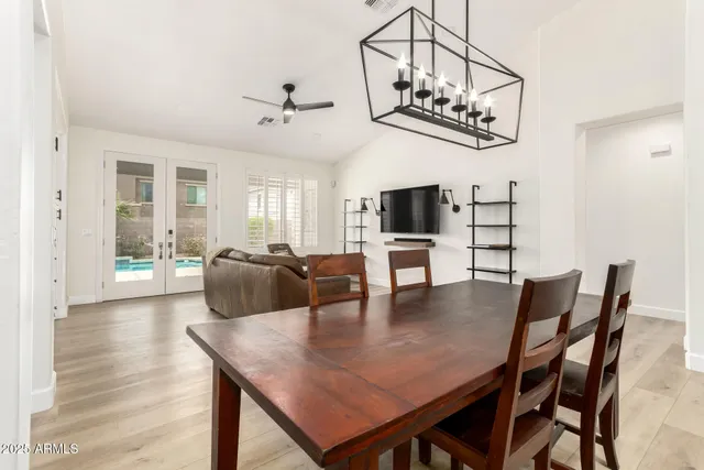 a view of a dining room with furniture and a chandelier