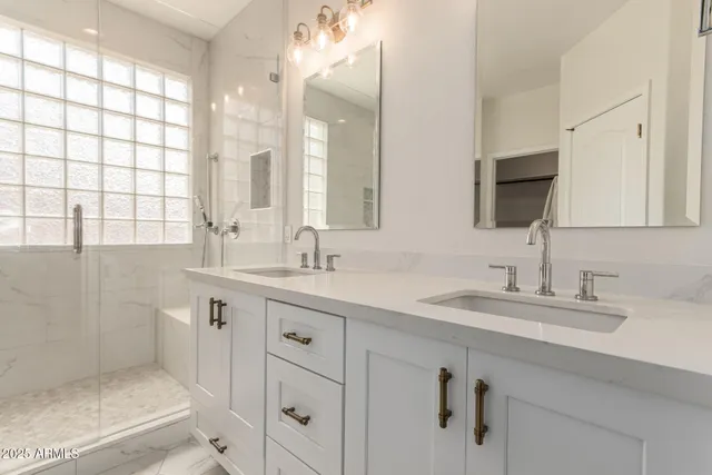 a bathroom with double sink and a mirror