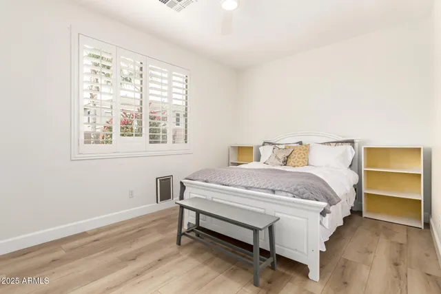a bedroom with a bed and window