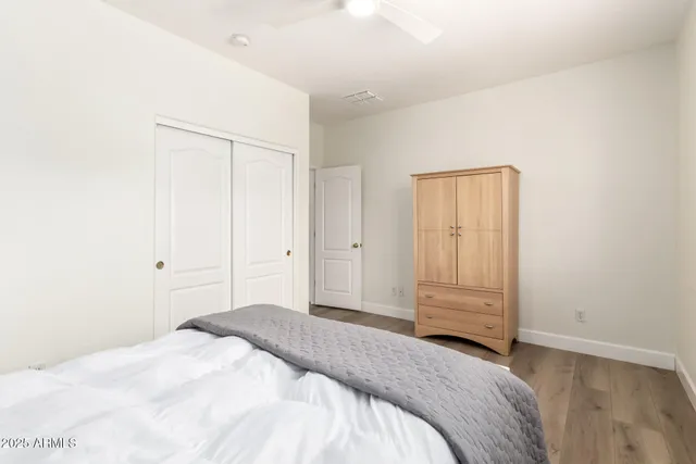 a bedroom with a bed and a closet