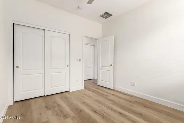 a view of an empty room and wooden floor