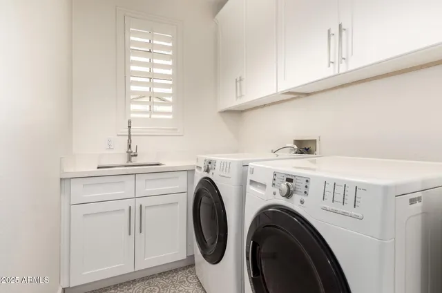 a utility room with sink dryer and washer