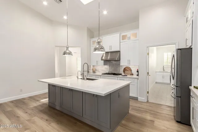 a kitchen with a sink a counter space and stainless steel appliances