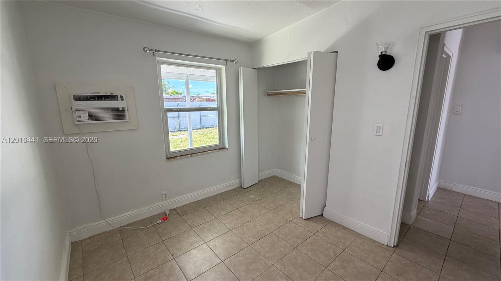 2230 Service Road Opa-Locka, FL 33054 - Photo 11 of 25 a view of an empty room with closet and a window