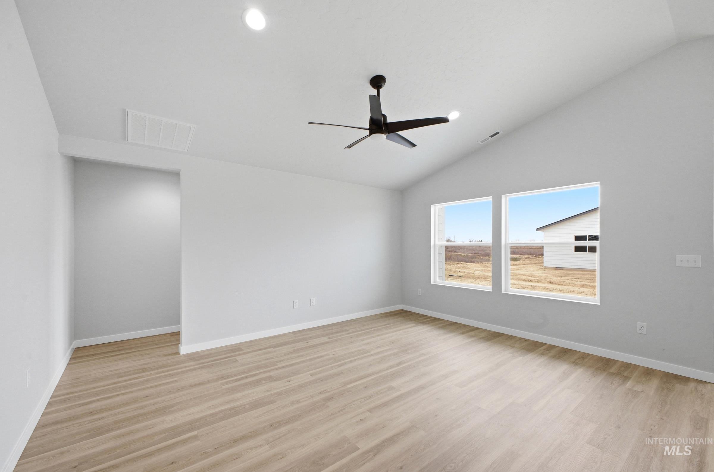 1598 Sunday River Street Middleton, ID 83644 - Photo 7 of 17 Vaulted ceiling featuring a modern black ceiling fan and recessed lighting