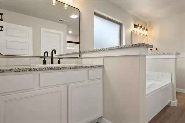 a bathroom with a sink and a mirror