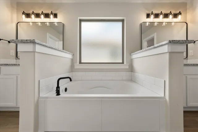 a white bath tub sitting next to a white sink