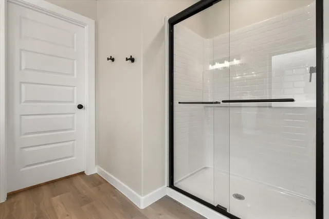 a bathroom with a glass shower door