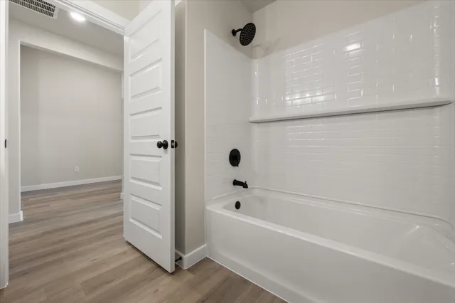 a bathroom with a bathtub and shower