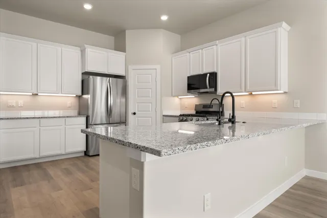 a kitchen with a refrigerator and a sink