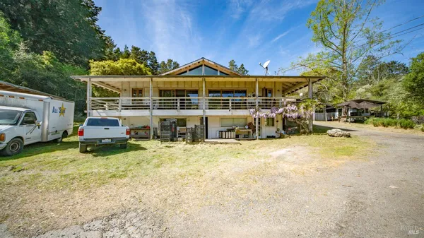 a view of a lush green outdoor space with swimming pool and valleys in the background