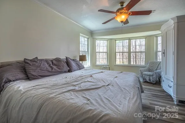a large bed sitting in a bedroom next to a window