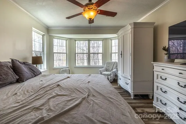 a bedroom with a bed and window