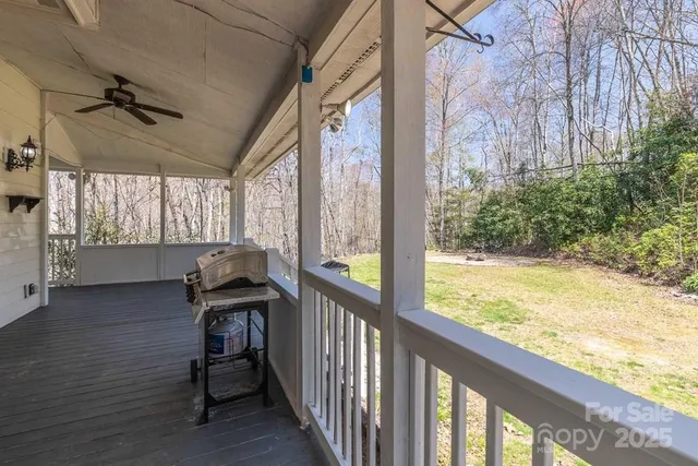 a view of a balcony with chair and wooden floor