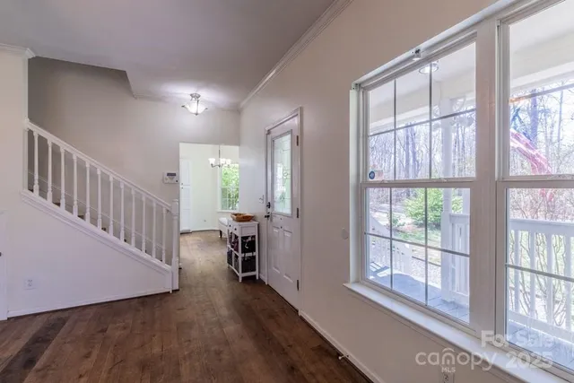 a view of entryway with wooden floor and a front door
