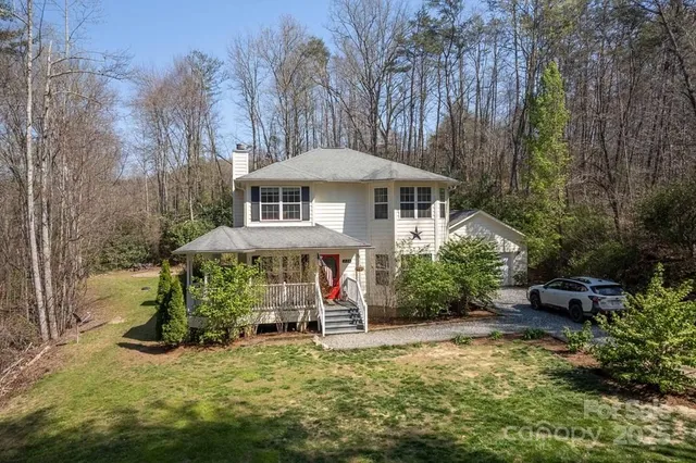 a view of a house with a yard garage and sitting area
