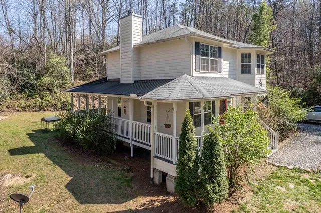 a front view of house with yard and trees around