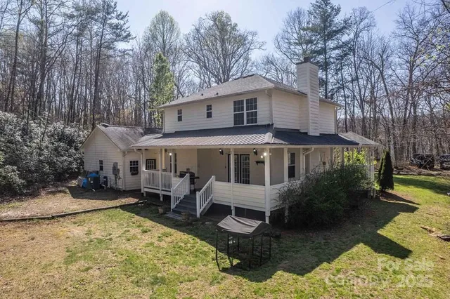 a view of a house with backyard water and sitting area