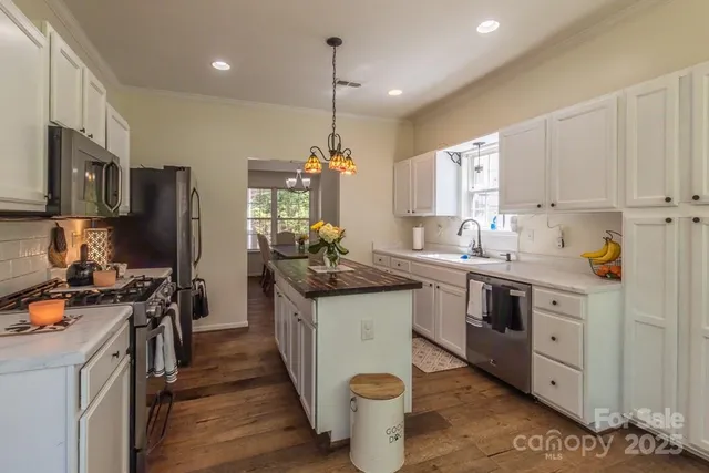 a kitchen with a sink stove and refrigerator