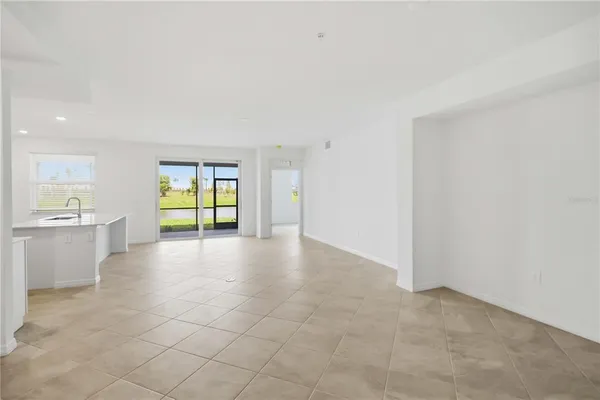 a view of an empty room with a kitchen