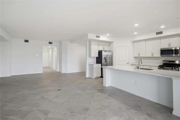 a kitchen with stainless steel appliances a refrigerator and a sink