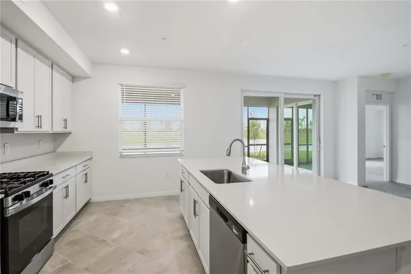 a kitchen that has a sink and a stove