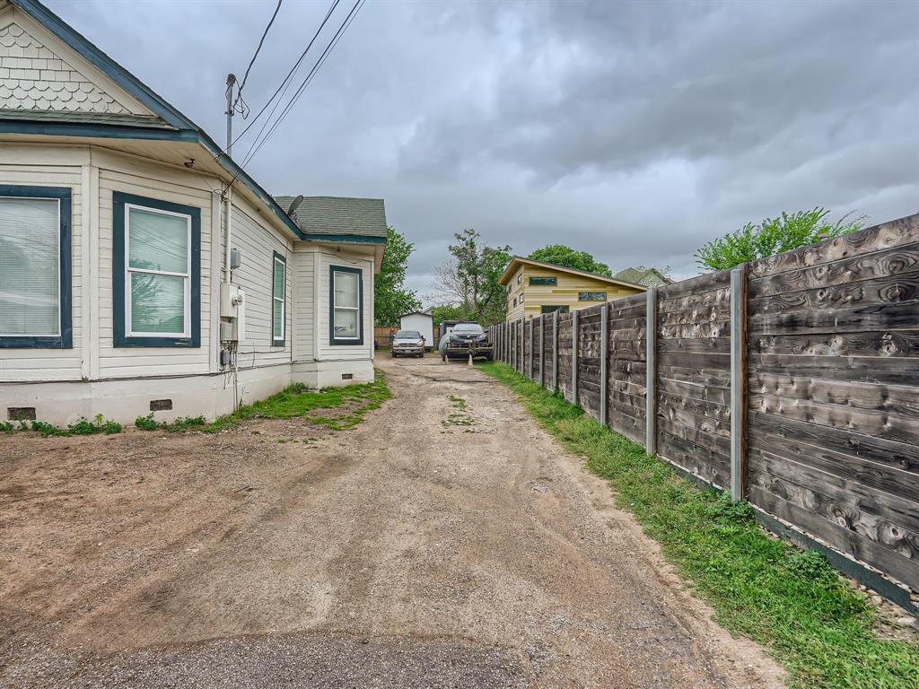 1122 Chicon Street Austin, TX 78702 - Photo 4 of 20 a view of a brick house with many windows next to a yard