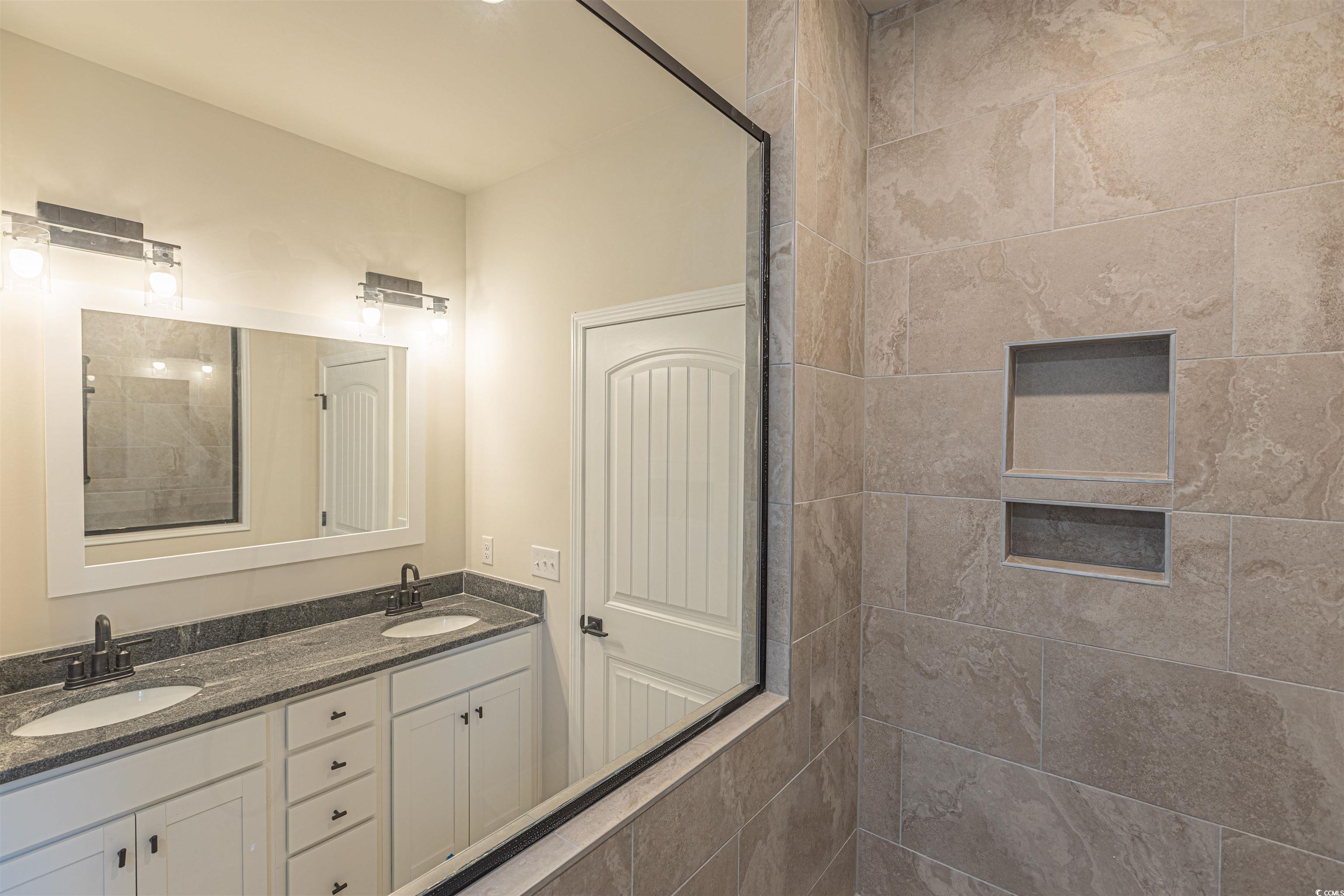 556 Honeyhill Loop Conway, SC 29526 - Photo 18 of 40 Full bathroom featuring a sink, double vanity, and