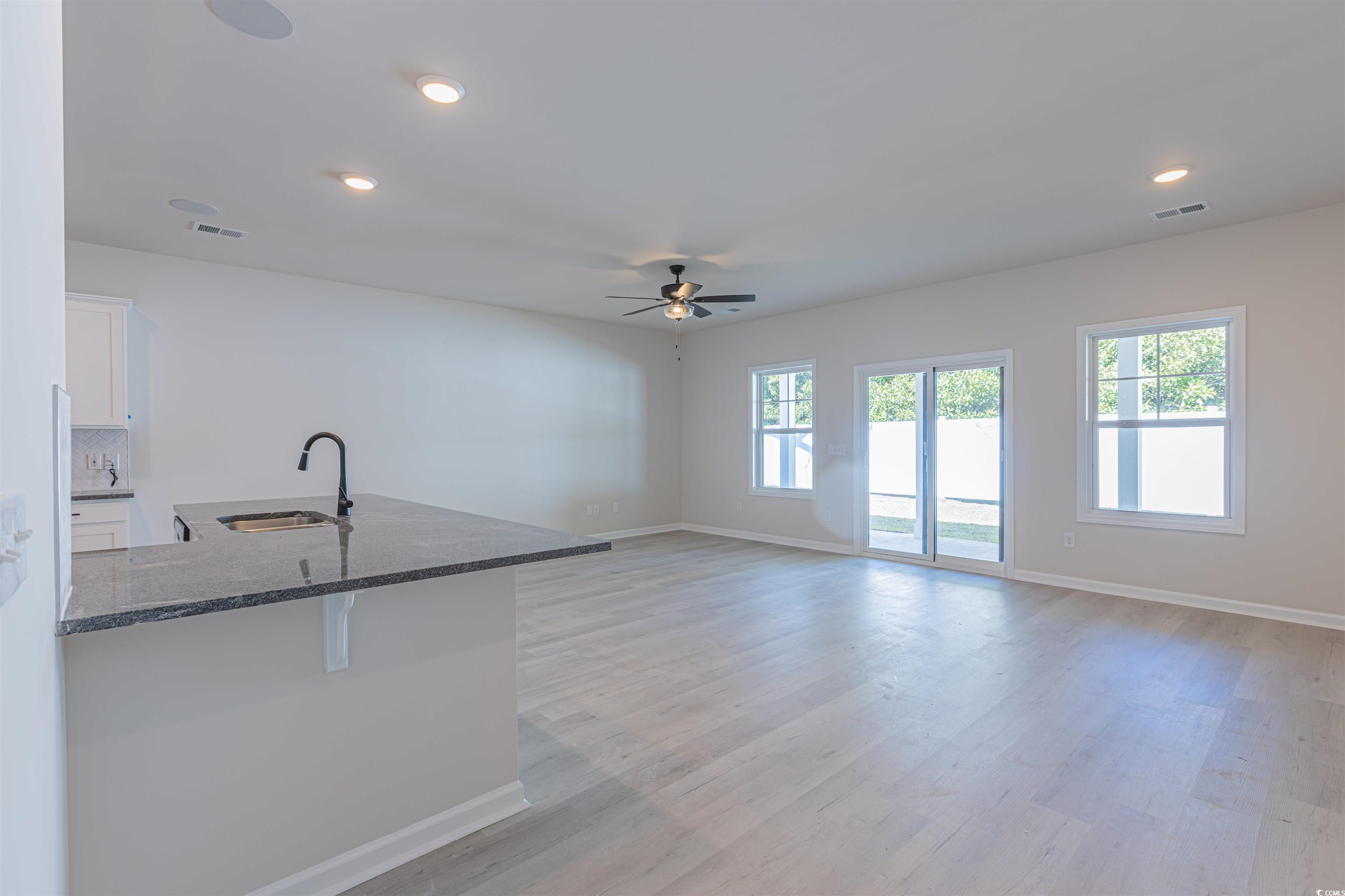 556 Honeyhill Loop Conway, SC 29526 - Photo 19 of 40 Kitchen with visible vents, a sink, dark stone cou