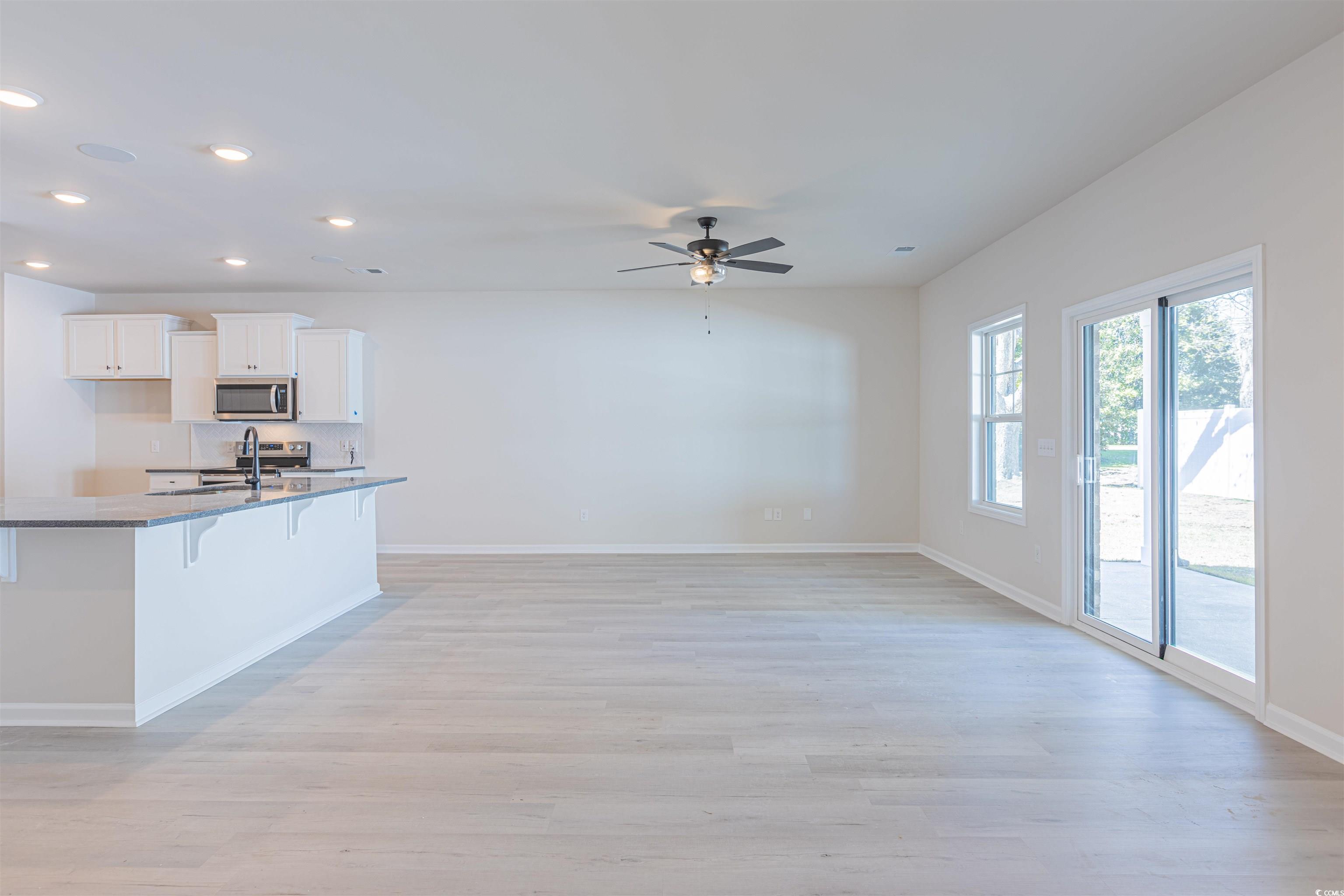 556 Honeyhill Loop Conway, SC 29526 - Photo 20 of 40 Kitchen featuring a breakfast bar, a sink, white c