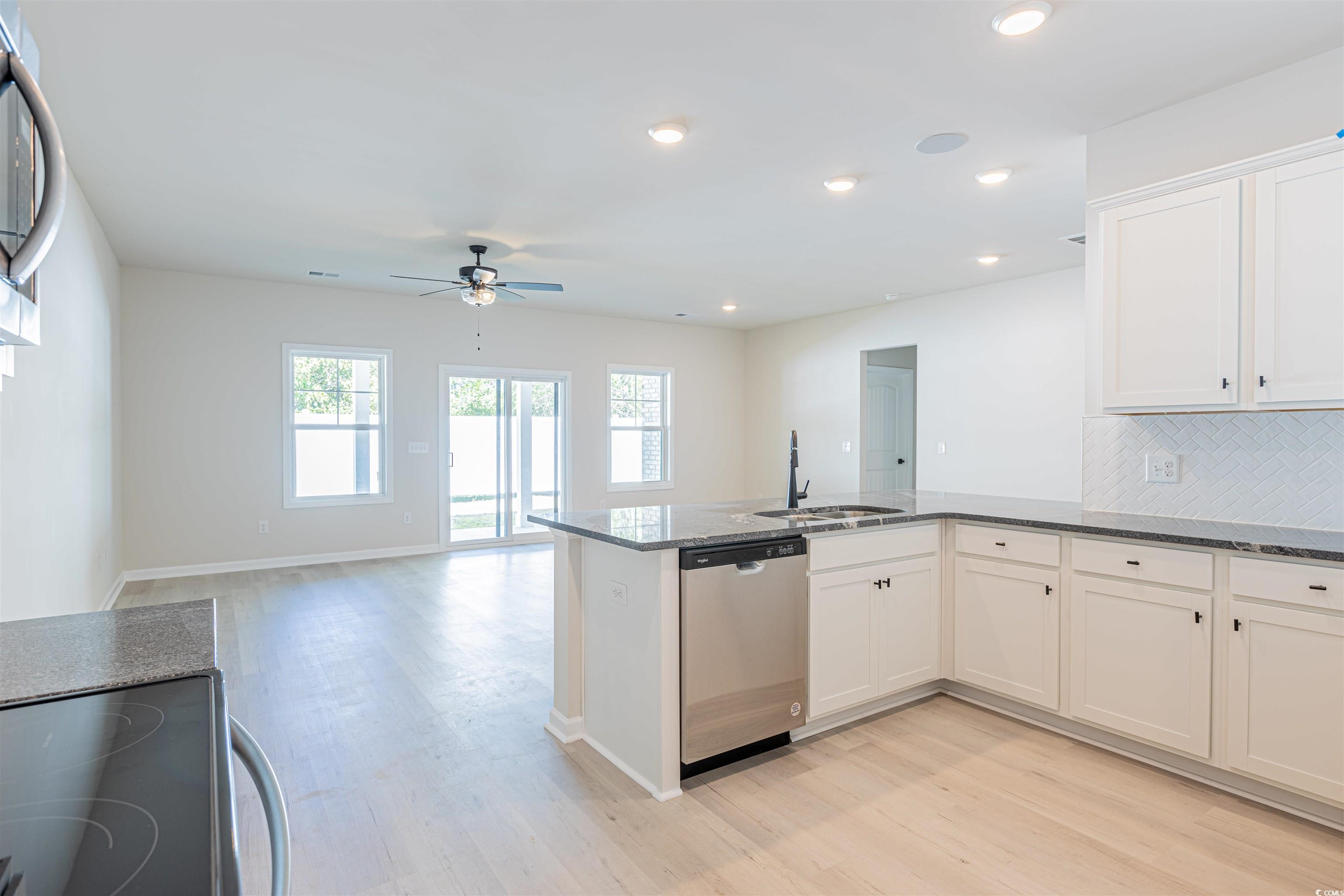 556 Honeyhill Loop Conway, SC 29526 - Photo 24 of 40 Kitchen with a sink, dark stone counters, stainles