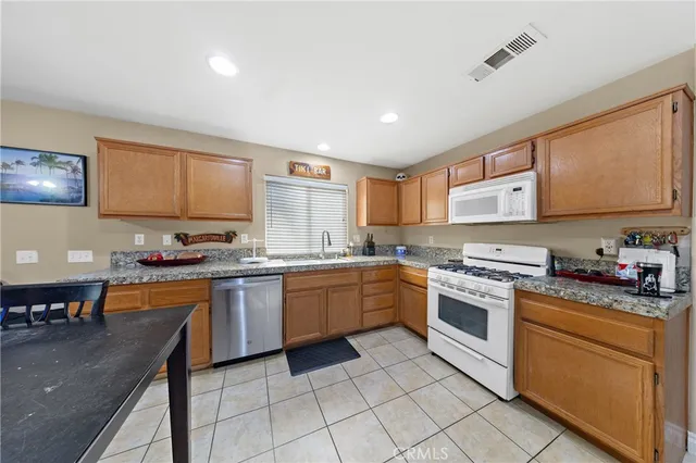 a kitchen with granite countertop appliances cabinets and furniture