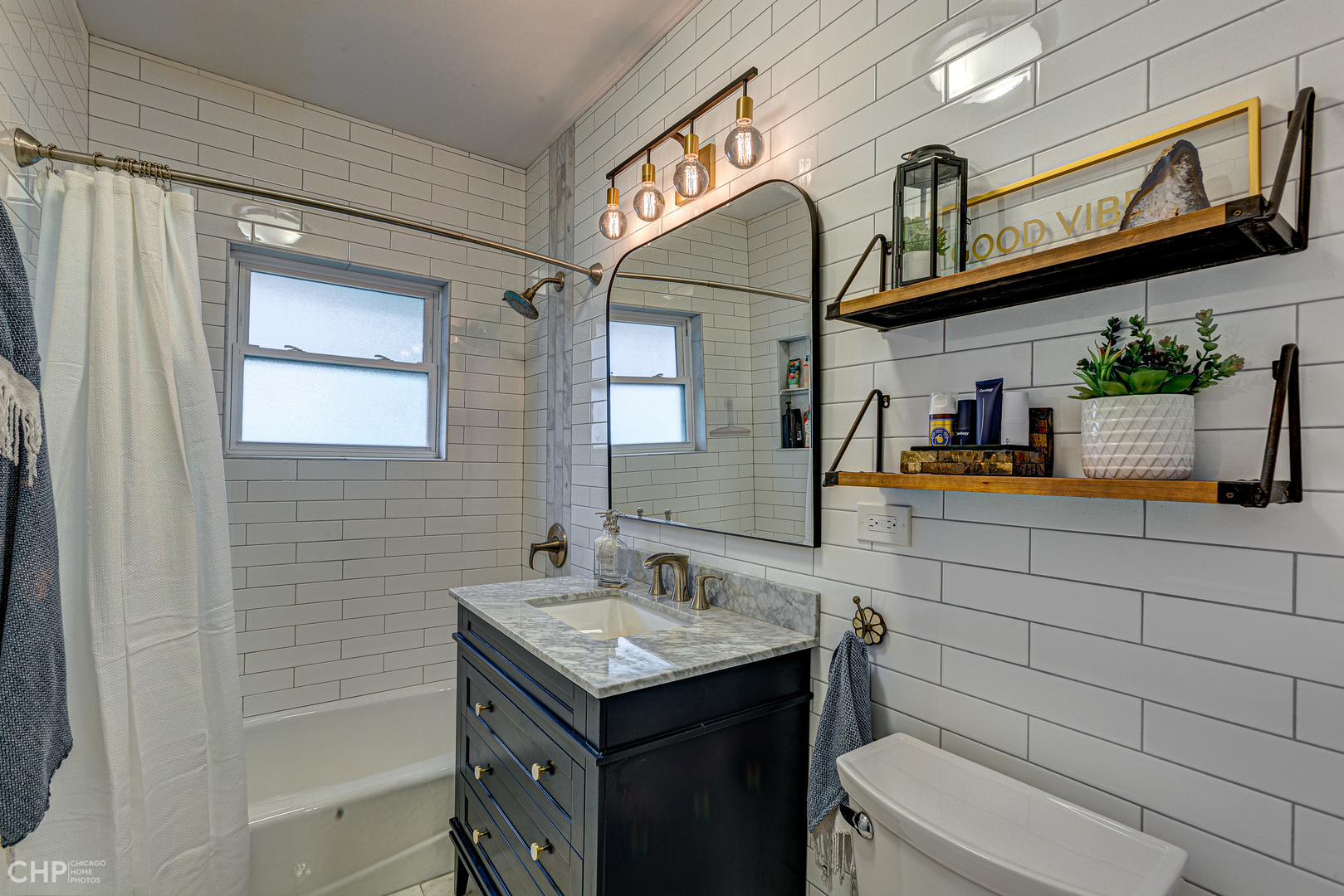310 Shenstone Road Riverside, IL 60546 - Photo 12 of 32 a bathroom with a sink a mirror and a shower