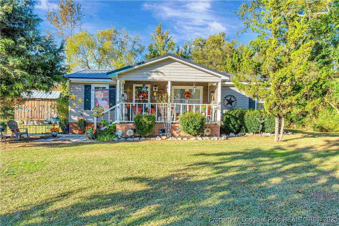 437 Paul Road Pembroke, NC 28372 - Photo 1 of 28 a front view of a house with a yard