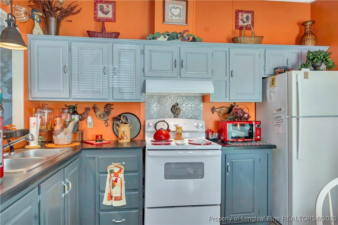 437 Paul Road Pembroke, NC 28372 - Photo 14 of 28 a utility room with stainless steel appliances granite countertop a refrigerator and a stove