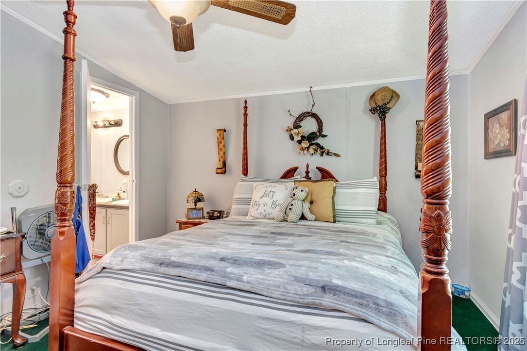 437 Paul Road Pembroke, NC 28372 - Photo 19 of 28 a bedroom with bed and a chandelier