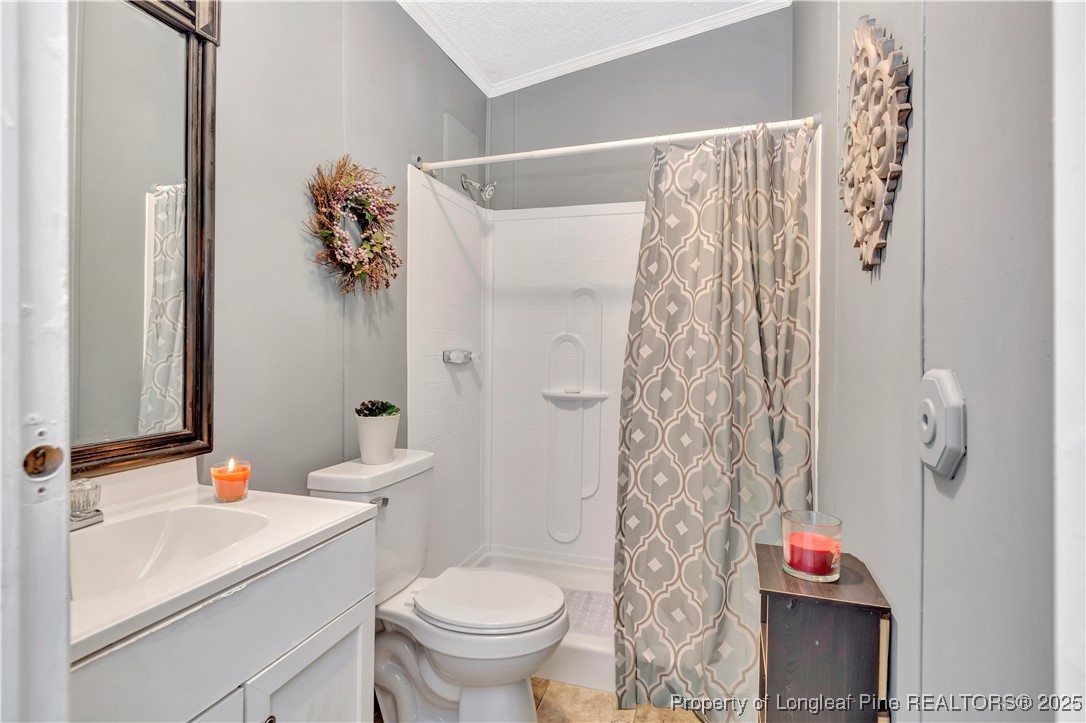 437 Paul Road Pembroke, NC 28372 - Photo 24 of 28 a bathroom with a sink toilet and shower