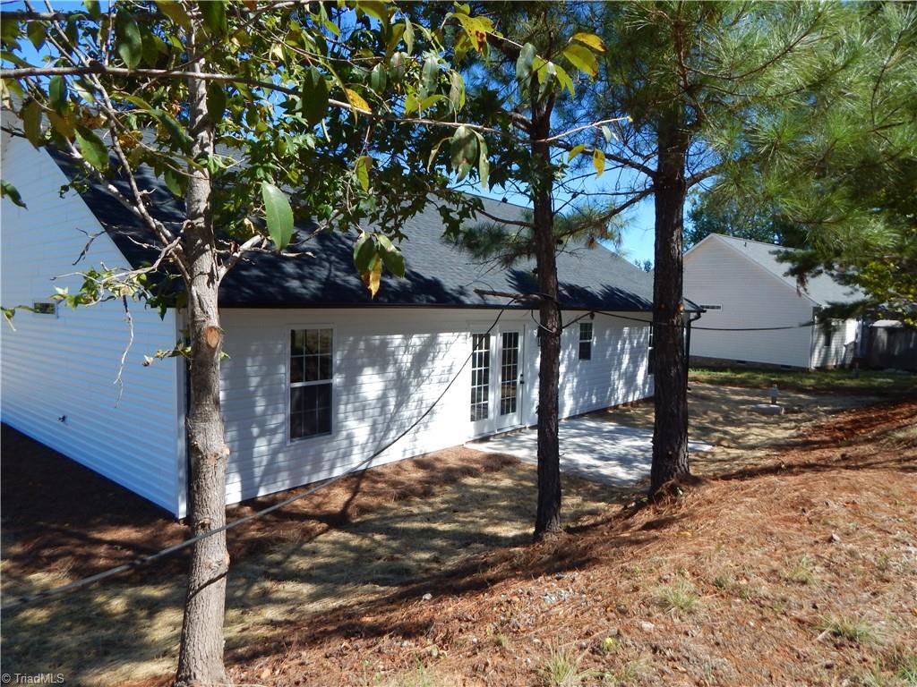 2126 Waterford Pointe Road Lexington, NC 27292 - Photo 15 of 15 View of rear of house and patio from common area. Comfortable privacy.