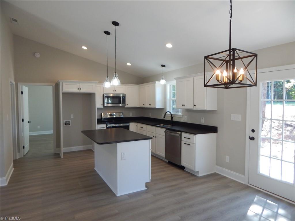 2126 Waterford Pointe Road Lexington, NC 27292 - Photo 5 of 15 Another view of dining into kitchen featuring granite tops and stainless appliances.