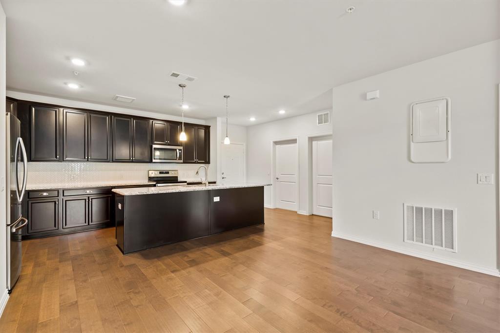 651 Watters Road, Unit 7202 Allen, TX 75013 - Photo 8 of 33 a large kitchen with stainless steel appliances lots of counter top space