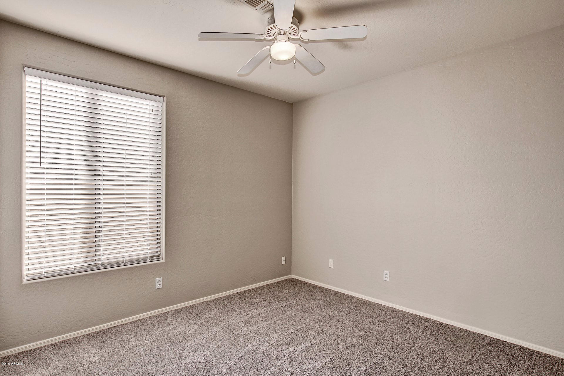 1360 East Harrison Street Gilbert, AZ 85295 - Photo 12 of 34 an empty room with a window and a fan