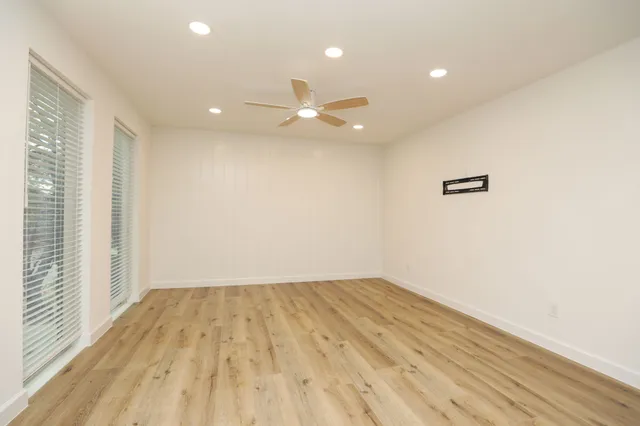 wooden floor in an empty room with a window