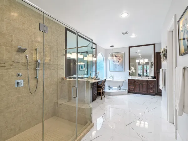 a bathroom with a tub shower and sink