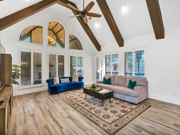 a living room with furniture and a floor to ceiling window