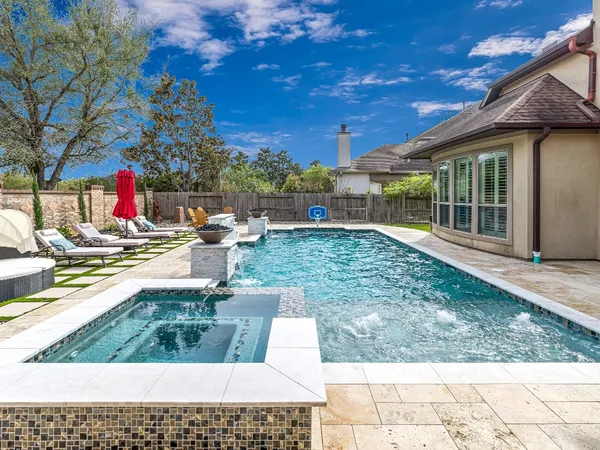 a view of a backyard with sitting area