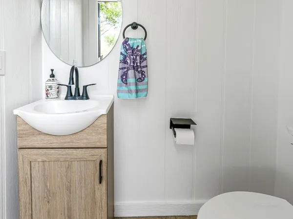 a bathroom with a sink a toilet and mirror