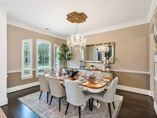 a view of a dining room with furniture wooden floor and chandelier