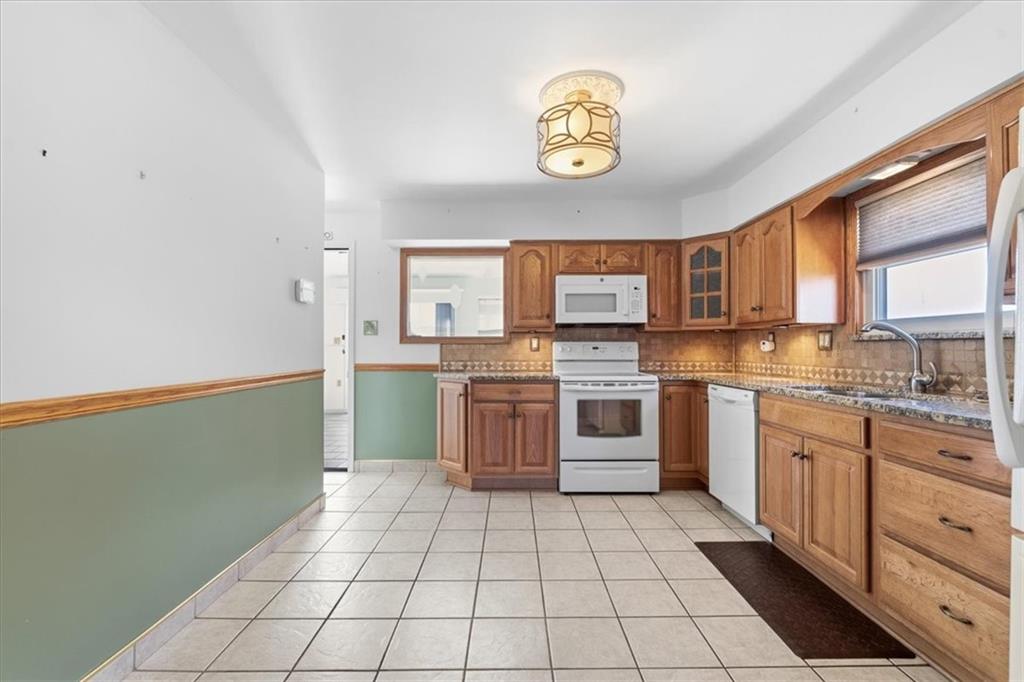 2355 Calvert Street Aliquippa, PA 15001 - Photo 11 of 28 a kitchen with a sink a stove top oven and cabinets
