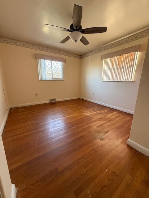 2355 Calvert Street Aliquippa, PA 15001 - Photo 18 of 28 an empty room with wooden floor ceiling fan and windows