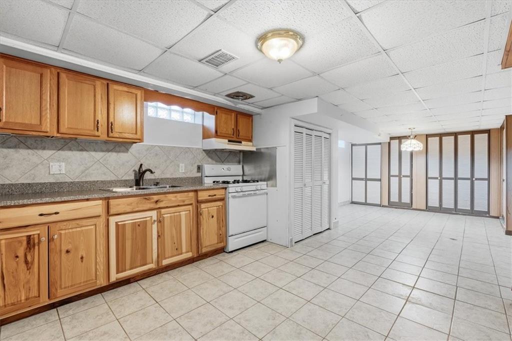 2355 Calvert Street Aliquippa, PA 15001 - Photo 24 of 28 a kitchen with granite countertop a sink window and cabinets